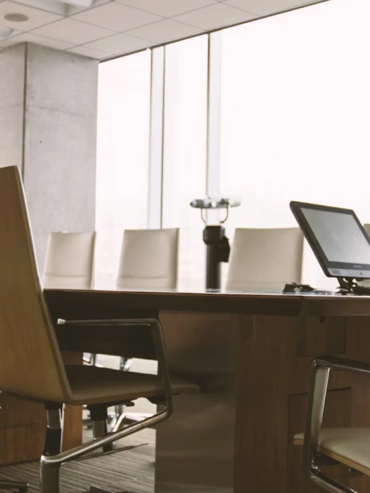 A long conference table and chairs in a meeting room