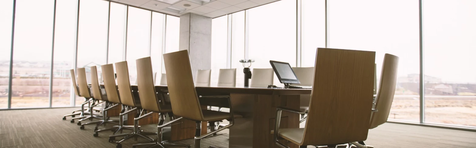 A long conference table and chairs in a meeting room